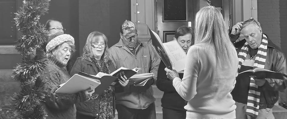 Alpine community members sang Christmas carols before the official lighting of the county Christmas tree this past Friday night at the Brewster County Courthouse. Photo by Kara Gerbert