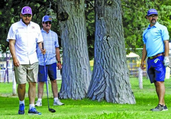 Michael Cruz steps up to drive his ball towards the green as Darrell Lambert and J.J. Alvarado look on during Sunday’s ANRS Exes annual golf tournament. Photo by Kara Gerbert