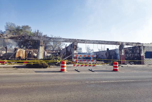 The 113-year-old Forcheimer Building in the 100 block of West Holland Avenue succumbed to a tragic fire Sunday evening. This photo from Tuesday morning shows the remnants of the popular downtown business scene and the smoke that’s still present two days later. Photo by Kara Gerbert