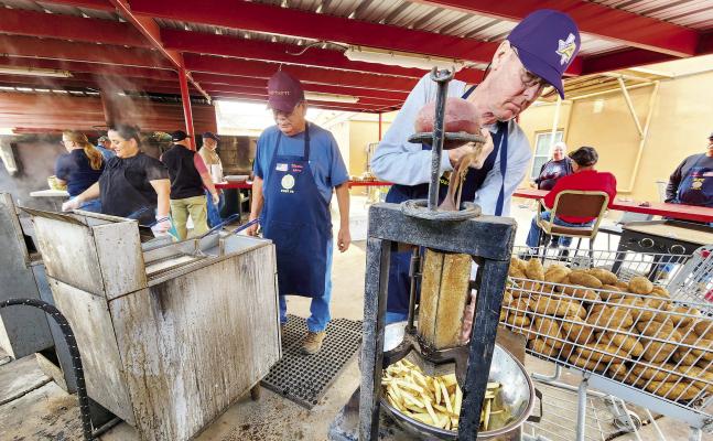 Charles Michaelis and Martin Sandate cut and fry up potatoes to make French fries for the American Legion Post 79 Fish Fry held last Friday evening. Avalanche photo by Kara Gerbert