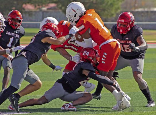 The Lobos work to tackle one of UT Permian Basin’s players during their final conference game on Saturday.