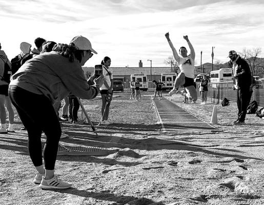 Valeria Crespo flies through the air during the long jump event at this past weekend’s Fightin’ Buck Relays. Crespo placed first in the event. Photo by J.T. Maroney
