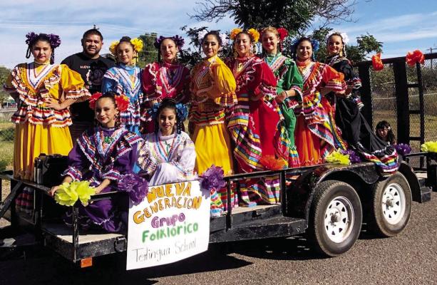 Folklorico dancers from the Nueva Generation Grupo Folkloric-Terlingua School showed off their colorful costumes while enjoying a ride aboard their float at the Halloween Harvest Festival Parade which took place in downtown Alpine on Oct. 22. The family friendly festival featured a costume contest for the kids, pumpkin carving contests, games, food, and more. Photo by Mary Ann Lujan