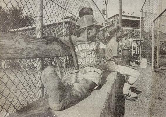 June 31, 1988 – Seven-year-old Ty Moreland is out for the season with a broken toe and has to watch his JBS teammates in Alpine Baseball League action from the bench.
