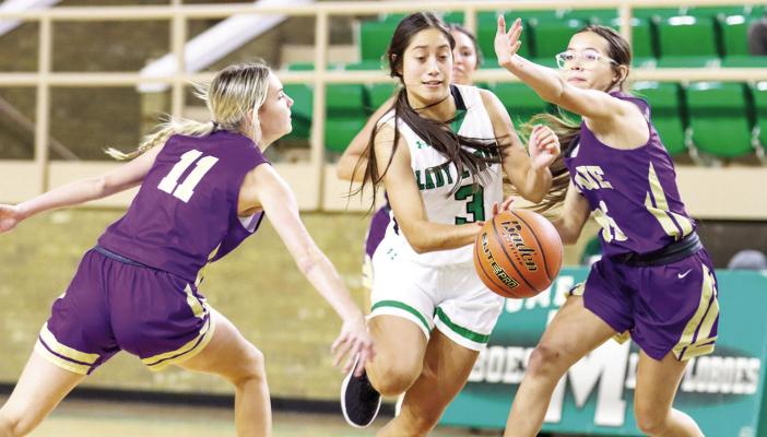 Alpine junior Ali Maroney, left, and freshman Nadia Morris apply defensive pressure to Monahans sophomore Adriana Soto on Saturday in Monahans. Photo by Shawn Yorks