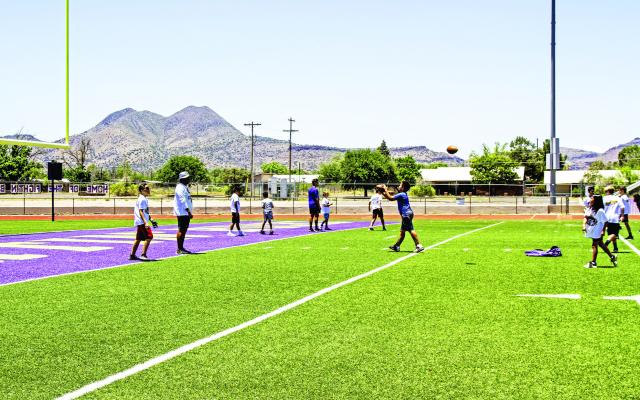A large number of local students came out to participate in Alpine ISD’s football camp held at Buck Stadium last week. These young athletes were taken through their paces with stretches, and skills drills by the Alpine coaching staff under the direction of Athletic Director Andy Smith. Photo by Kara Gerbert