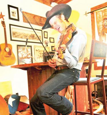 Musician Doug Moreland fiddles for a crowd. Courtesy photo