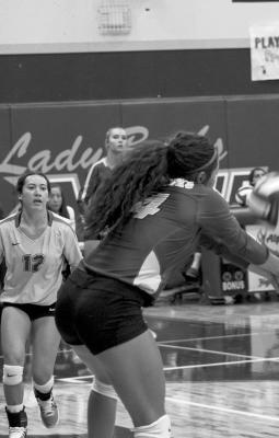 Alpine Lady Buck Novah Carrasco breaks the serve in a close match recently as Mia Morris looks on. Photo by Joh Covington