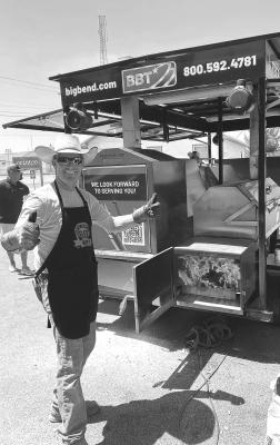 Left: Big Bend Telephone employee Kasey McComb mans the firebox at the BBT tailgate party and BBQ last Friday during Viva Big Bend. Photo by J.T. Maroney