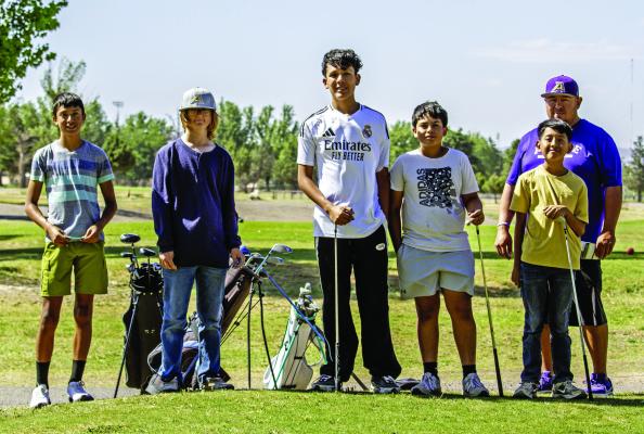 Alpine Buck middle schoolers Roman Holguin, Max Cramer, Tate Ortiz, Enrique Valenzuela, and Armando Adame take a moment to mug for the camera Tuesday afternoon, along with their Coach Marco Gomez, who had the young golfers practicing despite the breezy conditions. Photo by Kara Gerbert