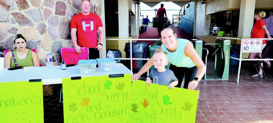 Chance Beam, 4, of Alpine is all smiles as he and mom Liz Beam welcome generous fans to an Alpine o6 Cowboys baseball game on Aug 4. Daulton and Liz Beam of Alpine Fitness hosted a back-to-school supply drive in front of Kokernot Field to raise money and collect school supplies for children in need. Alpine Fitness also donated $20 for every run the Cowboys drove in, hoping to get a match donation.