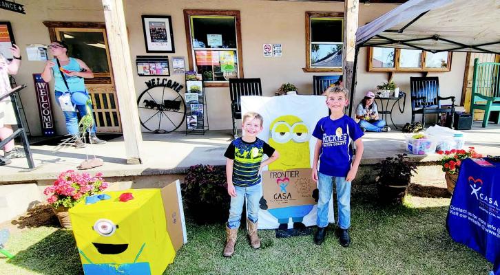 James Bell, 7, and Colin Bell, 10, of Alpine stand next to the Frontier CASA children’s display at the Family Crisis Center of the Big Bend’s Family Fun Day held on July 23 at the Alpine Visitor’s Center pavilion. Children of all ages enjoyed a bouncy house, face painting, free hotdogs, and games and activities, while guests interacted with local nonprofi ts, enjoying live music throughout the day.