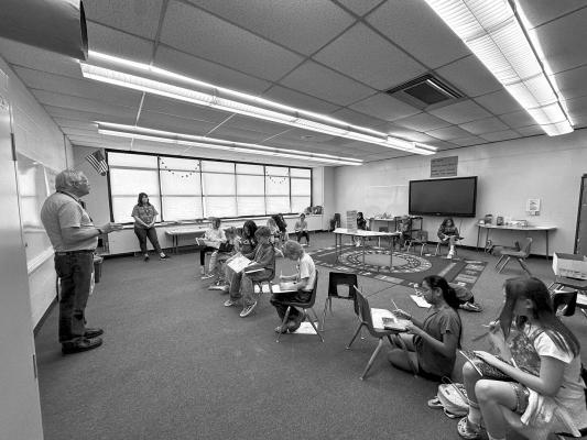 Alpine Elementary School principal Mr. Wubbena and AES counselor Mrs. Hendryx work with fourth graders in a specialized mini class that focuses on their writing skills as part of the preparation for the STAAR test. Courtesy photo