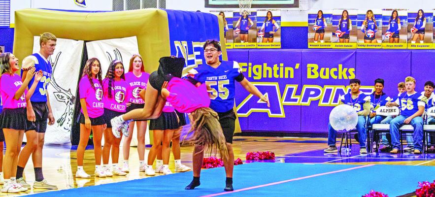 Senior Buck football player David Baca works on his spotting technique as part of the cheer squad at last week’s pep rally. Photo by Kara Gerbert