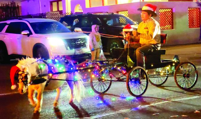 This adorable mini horse was all decked out for the holiday, pulling her master during Saturday’s Christmas parade. Photo by Kara Gerbert