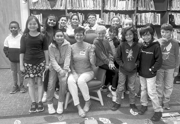 Alpine resident Judy Stokes is pictured here with students from Alpine Elementary, where she spends her free time fostering a love of reading to the students as part of the Read Alpine program. Stokes is a regular fixture in the library at AES. Courtesy photo