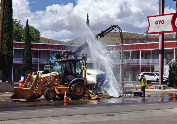 The City of Alpine works on a routine water leak on Monday, June 27, in front of the OYO hotel. Workers inside the hole cool off a bit during the repair as water shoots into the air from the waterline on East Holland Avenue Photo by Kara Gerbert