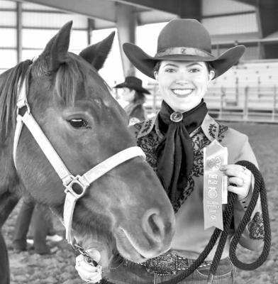 Jordan Miller shows off her first-place ribbon during the horse show held this past Friday at the Sul Ross SALE Arena. Photo by Felipe Fierro