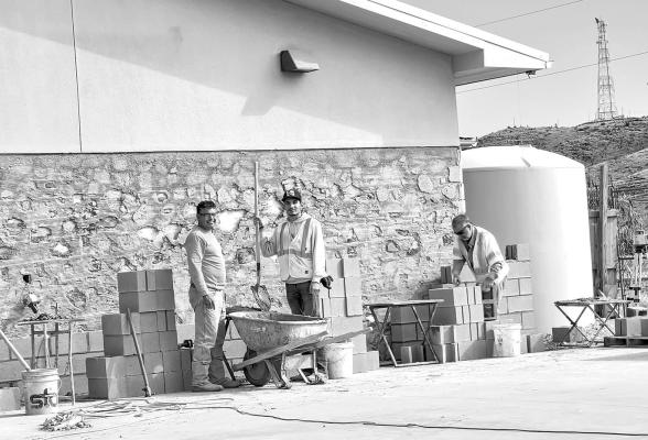 Construction workers are making progress on the Alpine Public Library remodel. After the demolition of the old awning and porch, a new slab was poured and completed just prior to the holidays. Construction on the firewall required for the build is now underway. Photo by Kara Gerbert