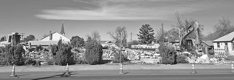 Jarratt Dirtwork out of Fort Davis has been systematically dismantling the former Alpine Medical Center where Dr. David Sanchez once had his medical practice. The property was purchased by Lowe’s to expand its parking options. Photo by Kara Gerbert