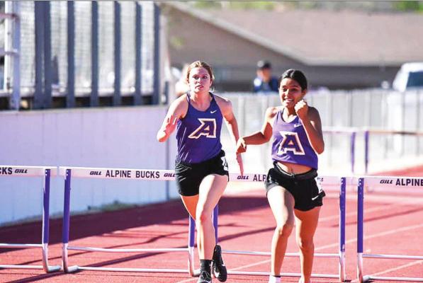 Lady Bucks Amanda Ahern and Jaycee Portillo run the 100-meter hurdles Thursday at the District meet in Alpine. Photo by Felipe Fierro