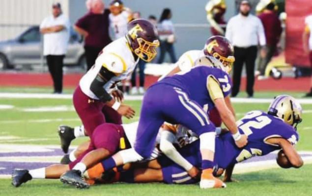 Fightin’ Buck Alejandro Hernandez goes down with the ball in a big win against Kermit on Sept. 24. Photo by Felipe Fierro