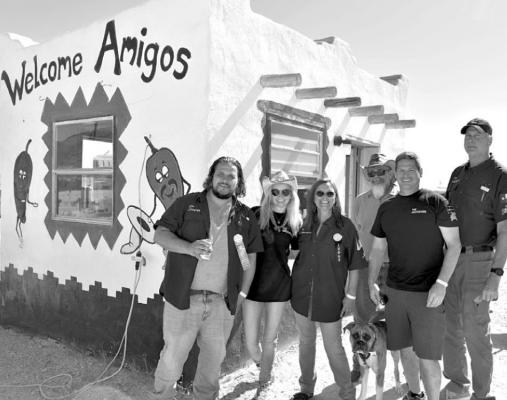 Competitive chili team the Groovers were on volunteer duty greeting visitors at the entrance to the Tolbert Behind The Store chili cookoff in Terlingua last weekend. Photo by Shawna Graves