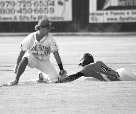 Cowboys shortstop Manny Garcia tags out Demarcus Kelly of the Weimar Hormigas on a stolen base attempt during a regular season game at Weimar Veterans Park on June 21. Photo by Julie Myers