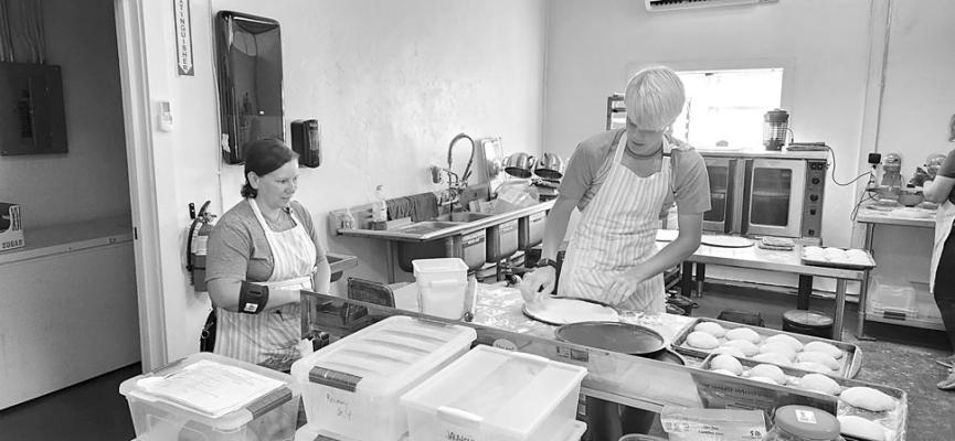 Bakery owner, Gabriela Pilonieta and Matheo Karleen get ready for the lunch rush by preparing fresh pizza dough.