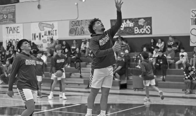 Alec Ramos warms up prior to a home game at the Buck Dome. Photo by Felipe Fierro