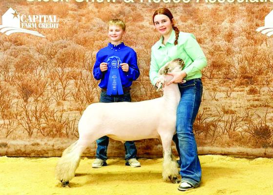 Twin Peaks 4-H member Rynn Matthews took home a first-place win with her finewool cross lamb this past weekend at the San Angelo Stock Show. Matthews is pictured with Wyatt Renfroe, also of Twin Peaks 4-H. Courtesy photo