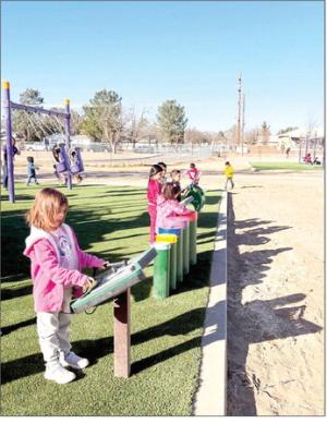 Students at Alpine Elementary enjoy checking out the new interactive portions of the new playground that was installed. Along with traditional playground equipment such as slides and swings, this new playground incorporated items such as this interactive musical component for students to learn and play on. Courtesy photo