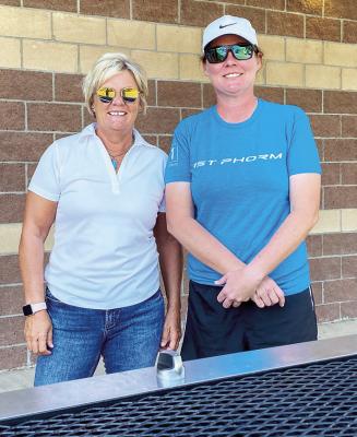 Alpine ISD school board member Mary McCallister and Marfa ISD Elementary School principal Amy White pause for a photo before the hamburgers went on the grill at the Coach Pancho Martinez Memorial annual scrimmage held in Marfa on Aug. 5. Avalanche photo by J.T. Maroney