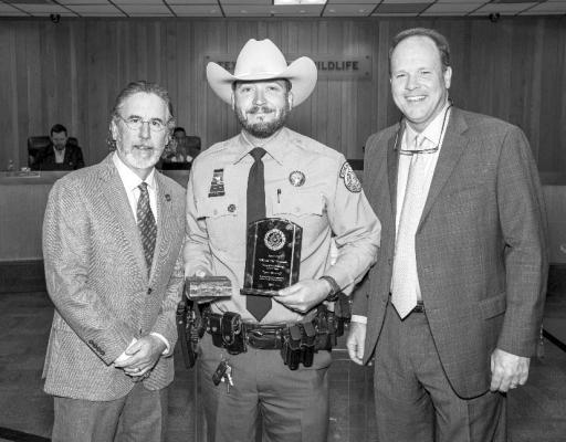 Texas Game Warden William ‘Bo’ Hancock receives the Game Warden of the Year award from Texas Parks and Wildlife Commission Chairman Arch “Beaver” Aplin, III and TPWD Executive Director Carter Smith. Courtesy photo