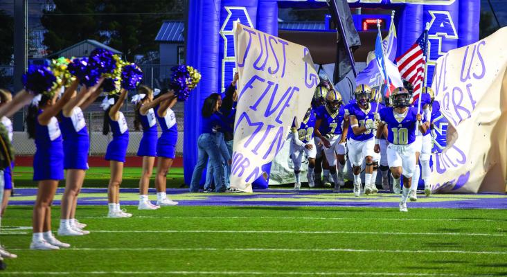 The Alpine Fightin’ Bucks run onto the field during a recent game on senior night. Photo by Virginia Acosta.
