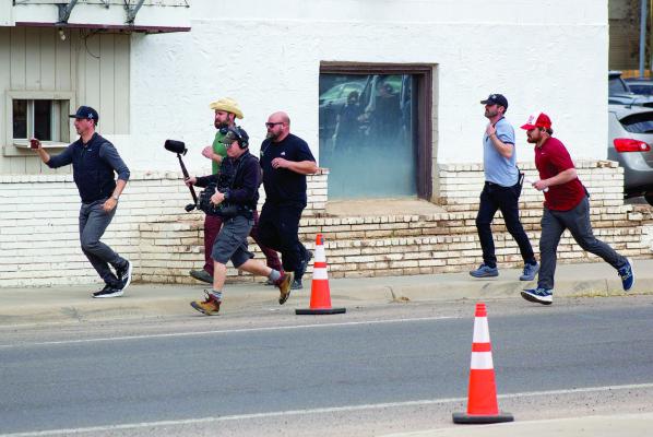 Part of the Due West filming crew follows the actor while shooting a scene in Alpine. Photo by Joh Covington