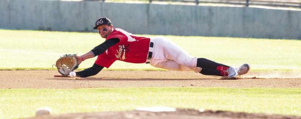 Alpine o6 Cowboys first baseman Bryce Donovan lays out for a diving stop during a first-round playoff game against the Trinidad Triggers at Kokernot Field on Aug. 4. Photo by Julie Myers