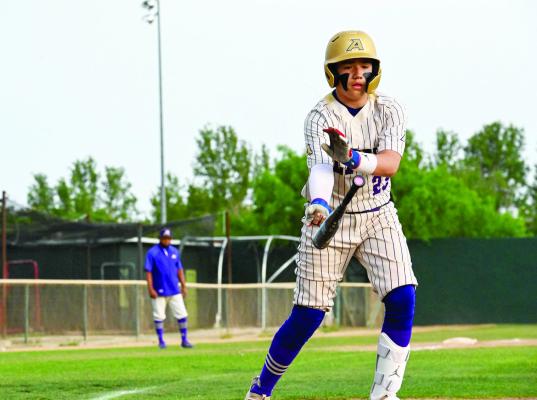 Ryli Vasquez tosses the bat as he prepares to leave home plate for first base. Photo by Felipe Fierro