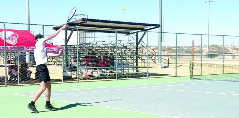 Zane Wash lobs a tennis ball to his opponent as the Fightin’ Buck varsity tennis team competed in the Mustang Tournament in Fort Hancock last week. Courtesy photo