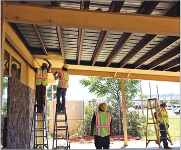 Local construction company Resnew Properties began demolition on the covered patio located on the west side of the Alpine Public Library last Friday. The old materials, such as the metal roofing and structural beams are being donated to the City of Alpine to be used in future construction projects.