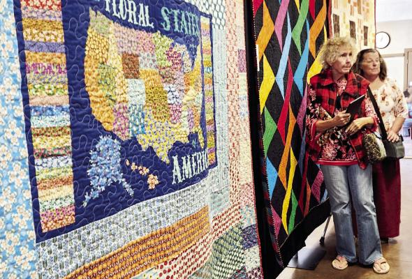 These ladies were just a couple of quilting admirers at the Sunshine House this past Saturday. The Desert Sky Quilting group displayed quilts of all sizes, held a raffle for a quilt, and had visitors vote on their favorites. Photo by Kara Gerbert