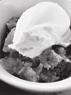 Warm peach cobbler with homemade whipped cream.