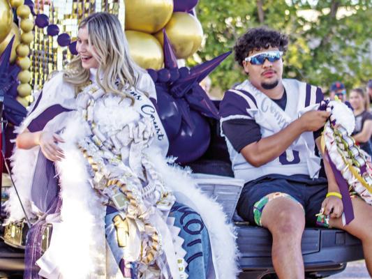 Queen and king candidates Peyton Kinkade and Alec Ramos shared a tailgate during last Wednesday night’s homecoming parade as they threw candy to well-wishers. Photo by Kara Gerbert