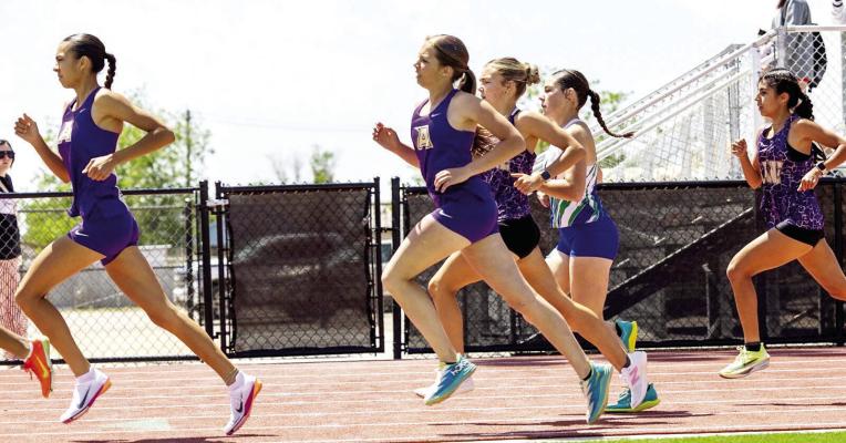 Lady Bucks Emy Hernandez and Hallie Wood make one of the many laps required during their 800-meter race at last weekend’s Area track meet in Kermit. Photo by Alice Saunders