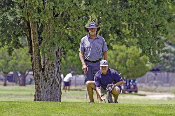 One of 56 teams to compete at this year’s Legends golf tournament, Bret Darter and Brian Harper who traveled all the way from Austin, line up a putt for a chance to become a Legends champion. Despite some much-needed rain, the twoday annual tournament concluded as scheduled Sunday evening. Photo by Kara Gerbert