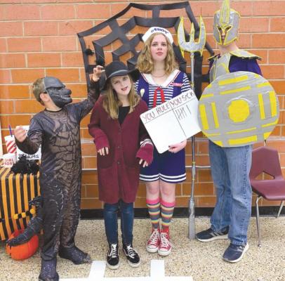 From Godzilla to a zombie, Keller, Elah, Bailey, and Jackson Barlow are ready for the costume contest at a past Fall Festival in Marathon. Courtesy photo