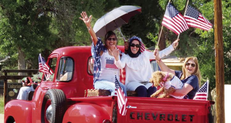 Eva Lambert, Cevahir Basibuyuk, and Coco Rodriguez Garza and her dog Chloe celebrate Independence Day in Alpine’s 4th of July parade in a vintage pickup owned by Sky Lambert. Photo courtesy of Sharon McClanahan