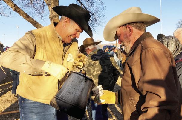 Campfire coffee is a staple at the chuckwagon breakfast for Cowboy Poetry participants such as cowboy cook Don McLeod, shown serving Don Cadden that much coveted cup o’Joe. Avalanche photo