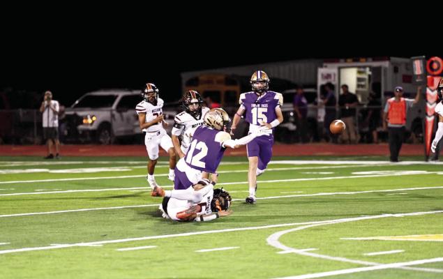 Alpine’s Thaddeus Prieto is taken down by a McCamey player, as Emerson Roach heads his way after he lost possession of the ball during the Fightin’ Bucks’ first game of the season last Friday night. Photo by Felipe Fierro
