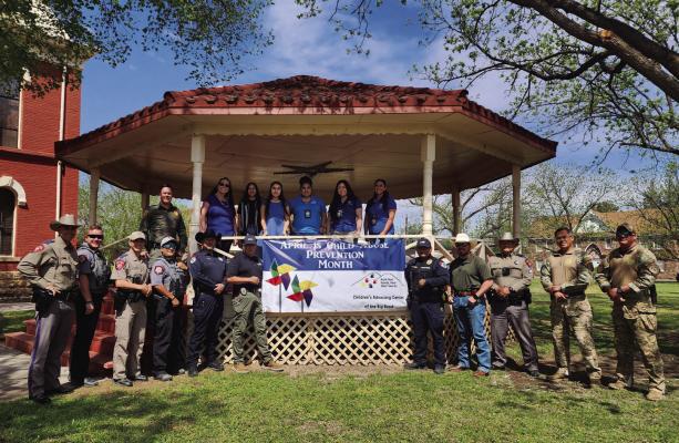 The Children’s Advocacy Center of the Big Bend (CACBB) posed for photos and held gatherings in the tri-county area last week to bring awareness to child abuse prevention. April is Child Abuse Prevention Month, and the director of CACBB, Shanna Sullivan, along with members of her staff, Child Protection Agency staff, and several branches of area law enforcement that work hand in hand with Sullivan, posed for a photo at the Brewster County Courthouse last week. Photo by Kara Gerbert